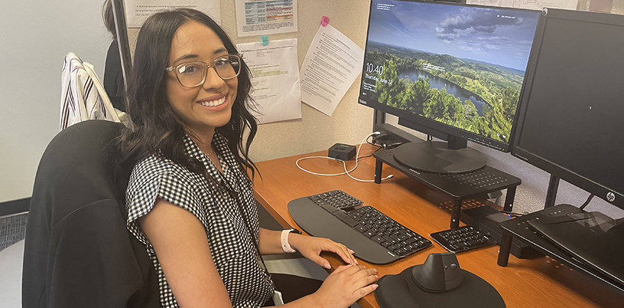 photo of young woman smiling at her computer